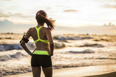 Exercise by the beach woman in a sports bra