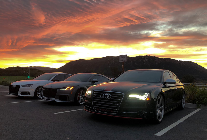 Audi's at a meetup place for cars and coffee